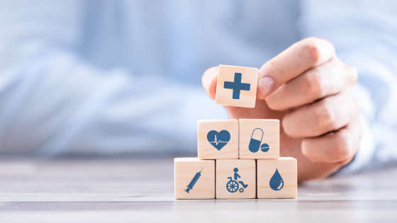 a stack of blocks with icons on them representing health insurance for seniors