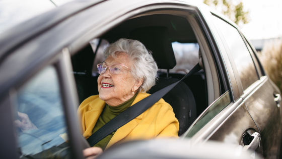 an elderly woman driving