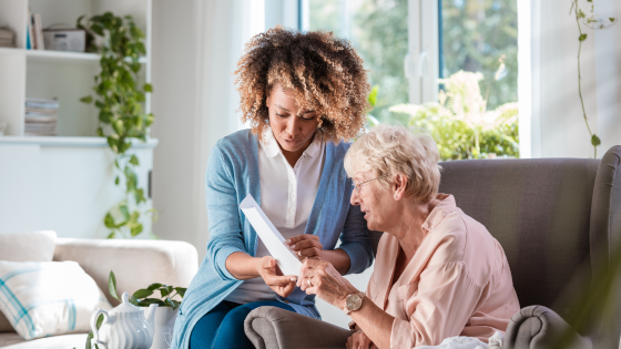 A woman talks to an elderly driver about driving with dementia