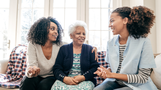 A family talking to an elderly driver about driving with dementia