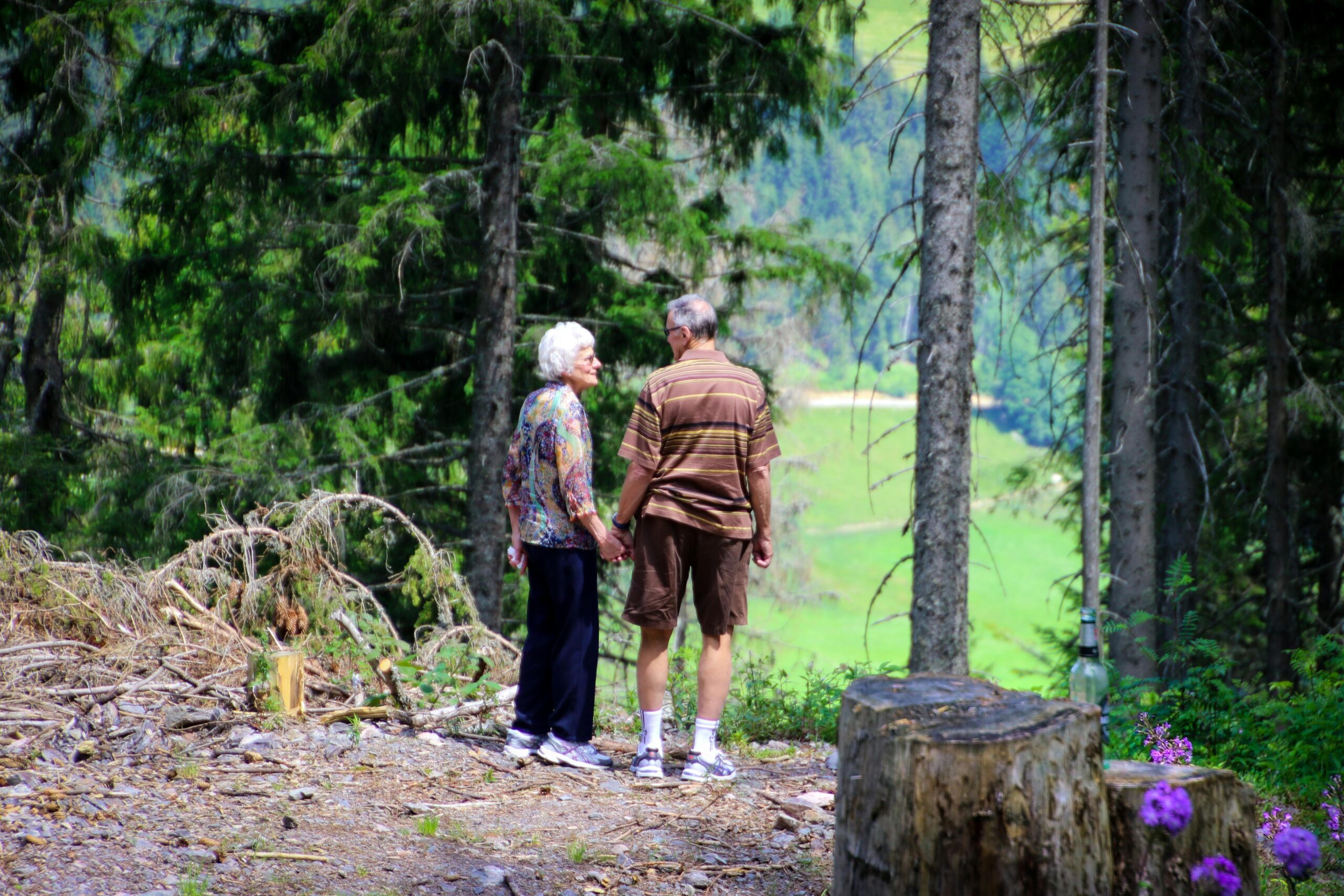 Older-couple-holding-hands-in-the-forest