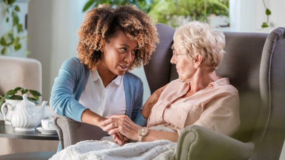 a staff member works with an elderly person at a nursing home